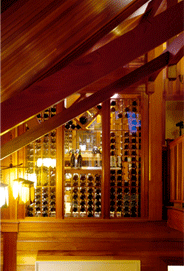 This conditioned wine loft in the Hamptons was placed high in a two story media room so as to showcase a noteworthy collection and to capitalize on the qualities of light, reflection & rich color inherent in wine storage.