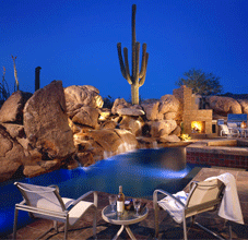 An outdoor environment in Scottsdale makes the most of a small back yard. Highway noise beyond is mitigated by a waterfall which helps privatize both visually and audibly.